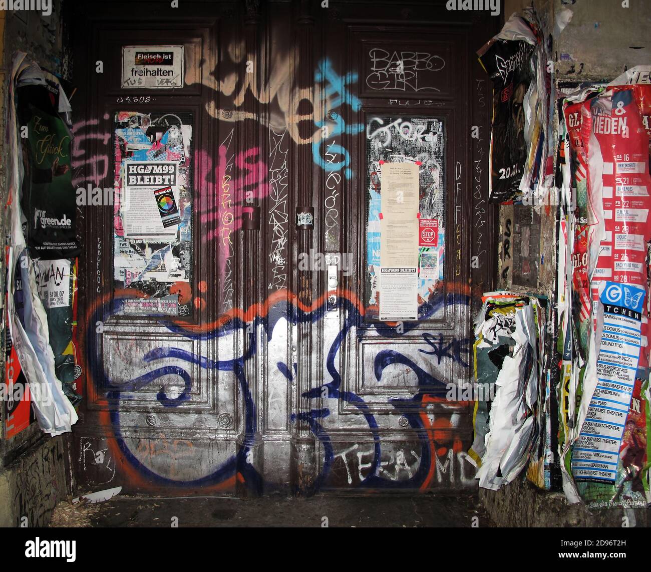 Graffiti - ridden entrance door of residential building in Berlin, Germany Stock Photo