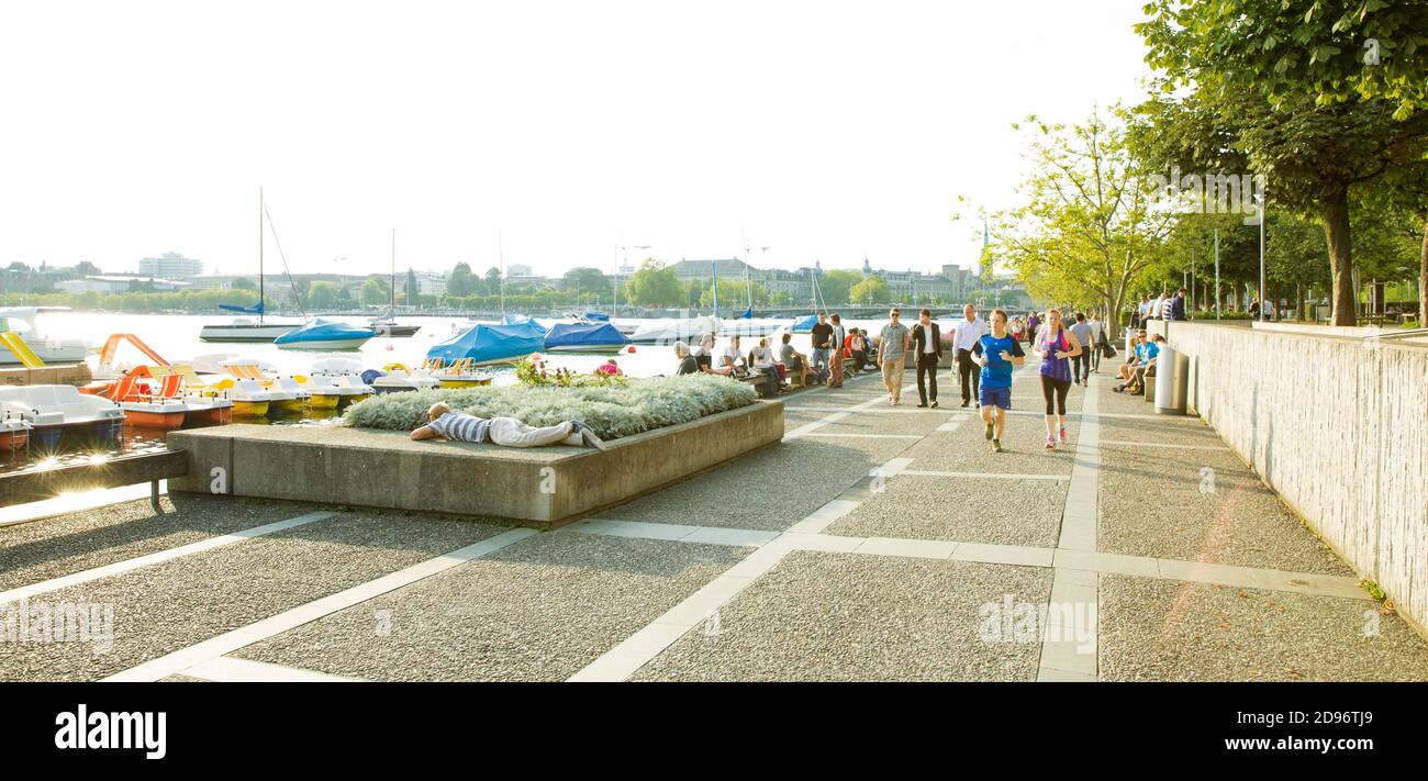 Zurich, Switzerland - July 23, 2014: People socializing on the bank of Zurich lake in Switzerland Stock Photo
