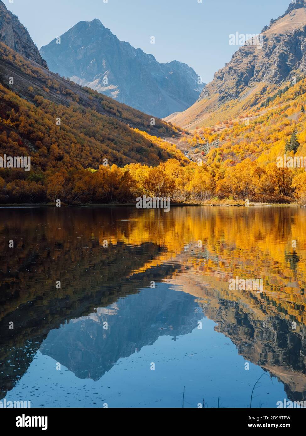 Mountain lake with transparent water, reflection and colorful autumnal ...