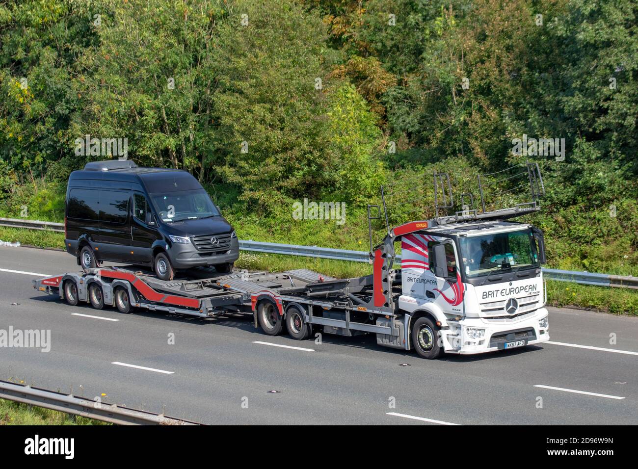 Brit Europeran Auto transporter, car transporter carrier; Motorway heavy bulk Haulage delivery trucks, haulage, Mercedes Benz Actros lorry, transportation, collection and deliveries, Rolfo multi-car commercial vehicle carrier, truck, special cargo, vehicle, delivery, transport, industry, freight on the M6 motorway. Stock Photo