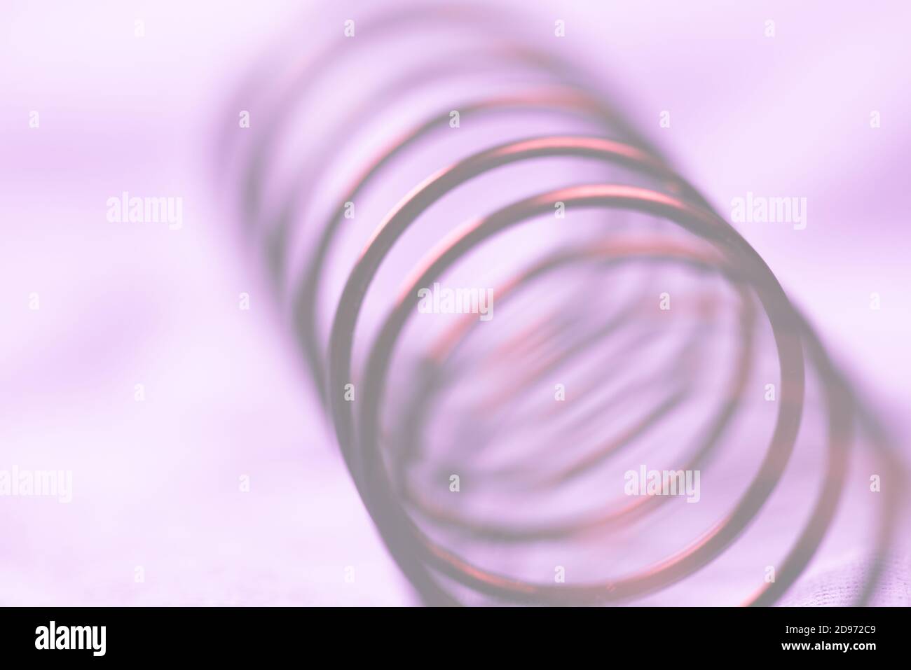 Details of a metal spring on blue cloth Stock Photo - Alamy