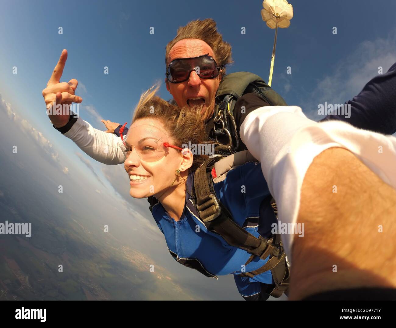 Selfie tandem skydiving with pretty woman Stock Photo