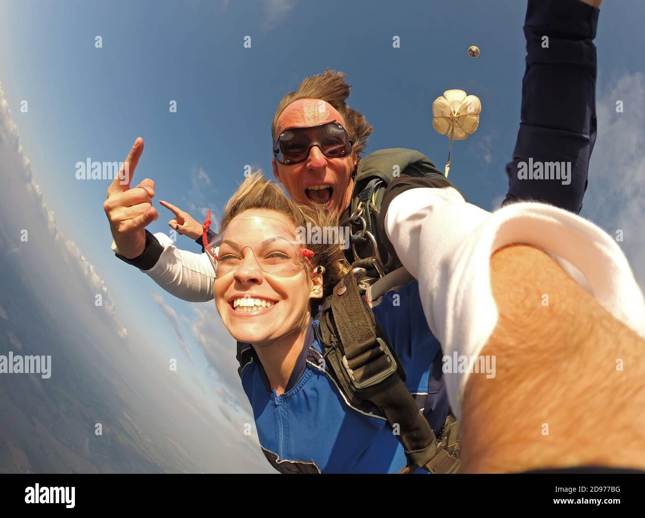 Selfie tandem skydiving with pretty woman Stock Photo