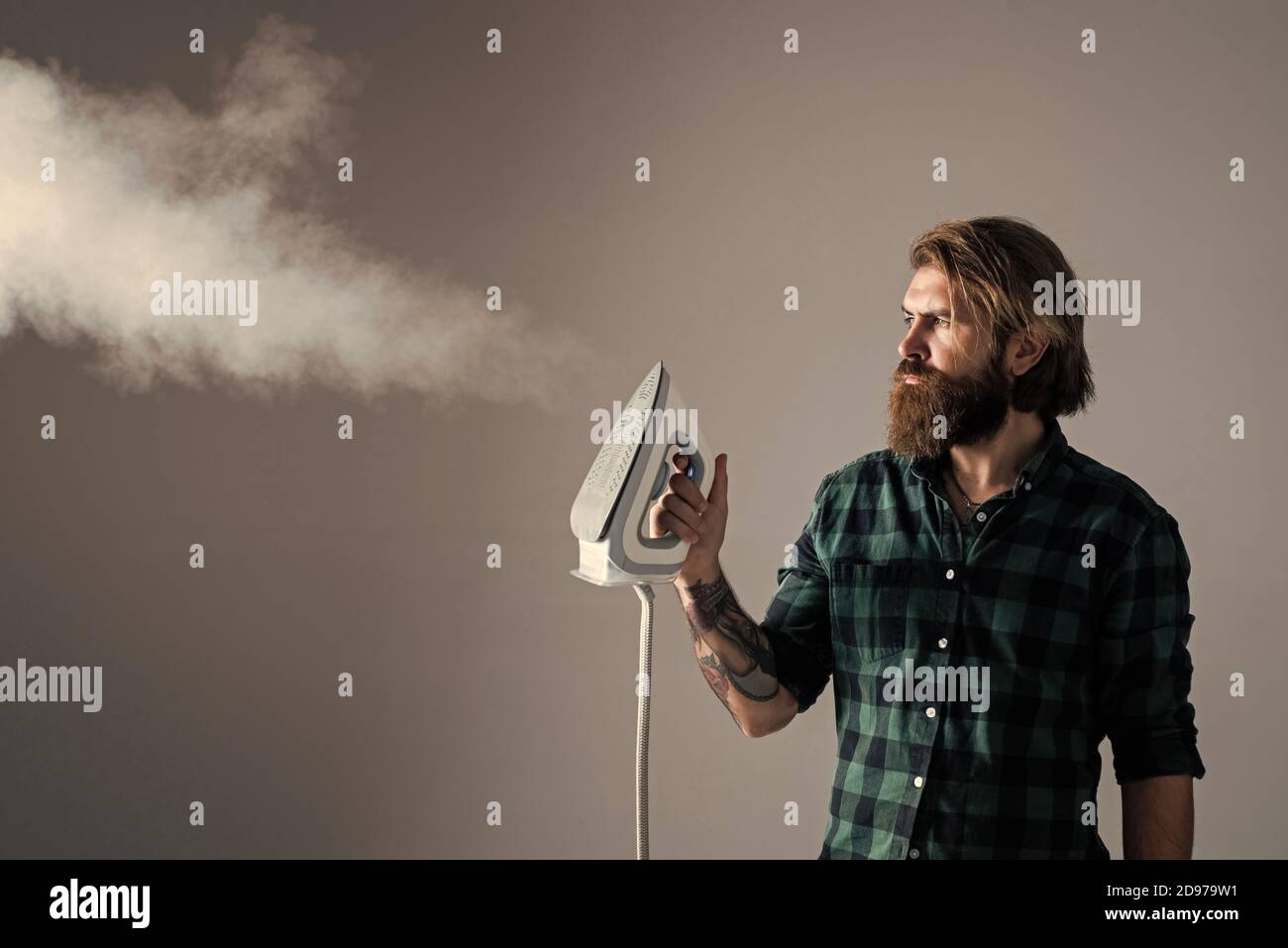 Professional Service. Man at home ironing clothes. house husband