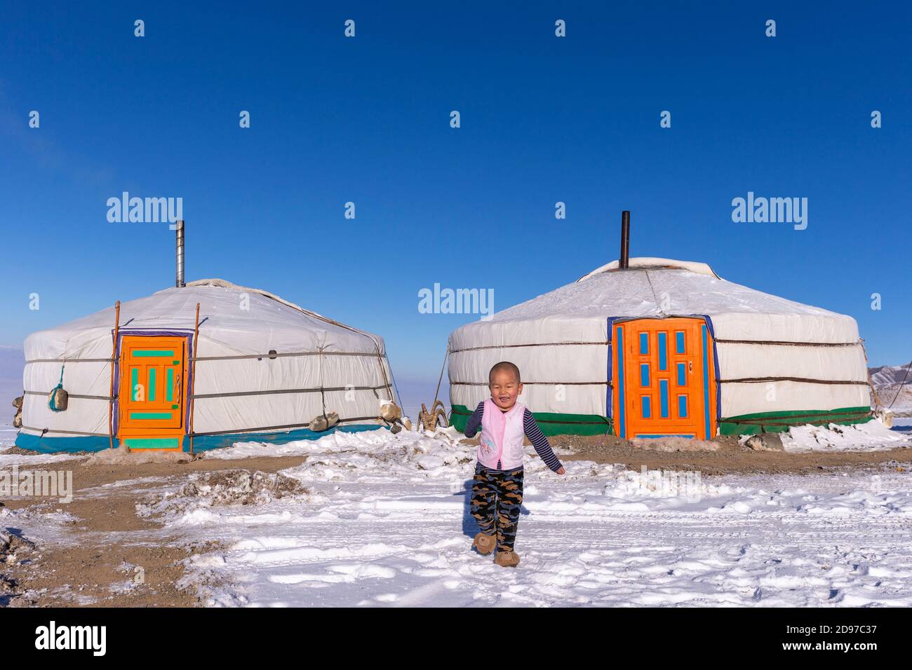 Yurt in the snow with a child, Altai mountains, West Mongolia, Mongolia Stock Photo