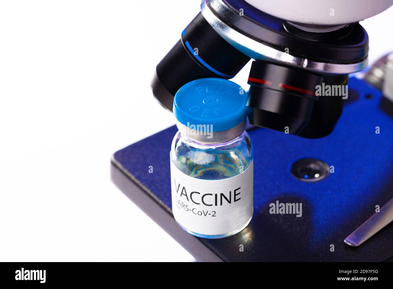 Vial of Covid-19 vaccine next to a microscope Stock Photo - Alamy