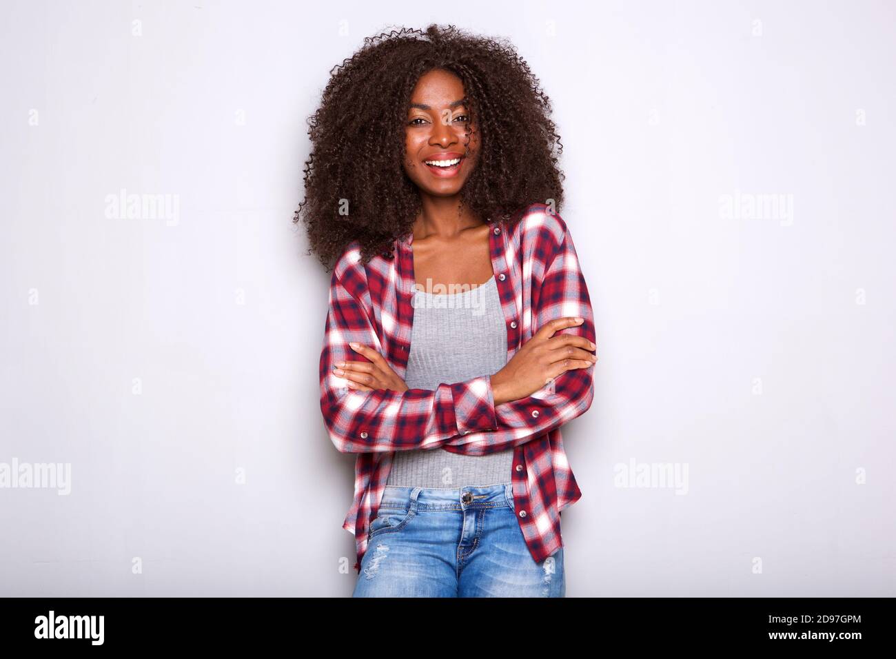 Portrait of stylish young african american woman standing with her arms ...