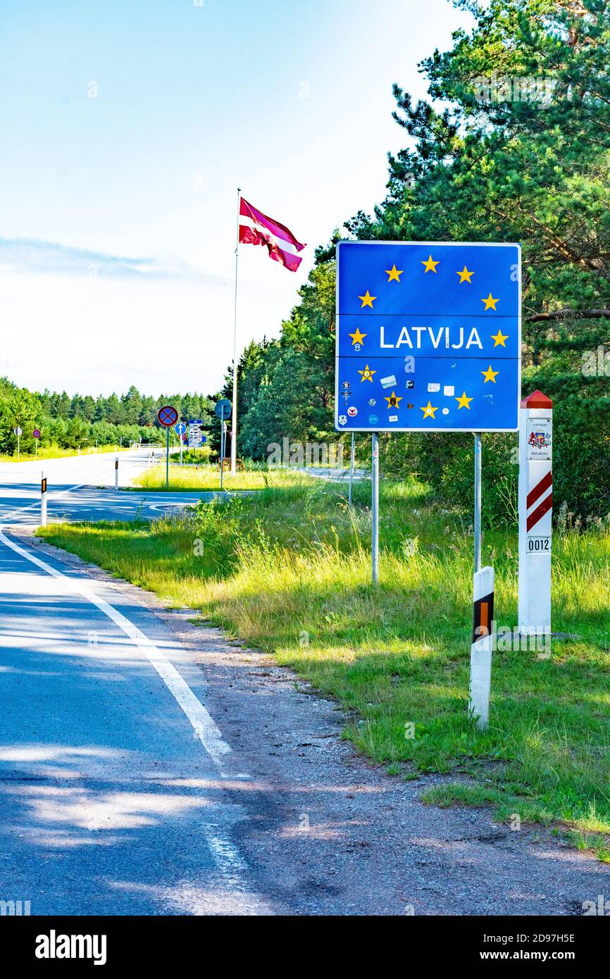 Latvian border with flag waving in the sky, Baltic countries, European Union, Baltic bubble, vertical Stock Photo