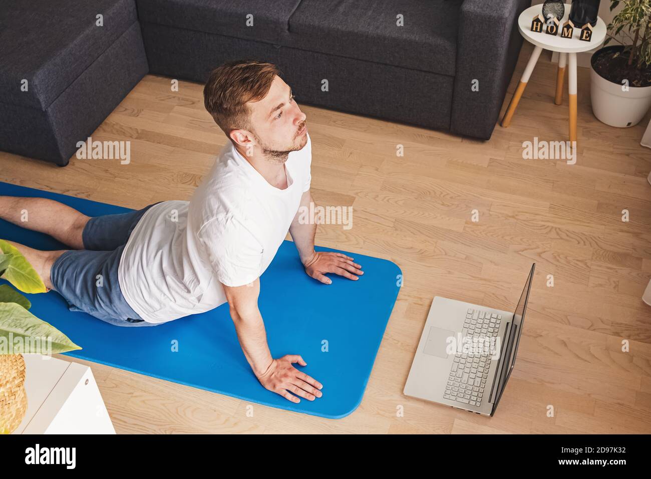 Young man doing yoga in his living room Stock Photo