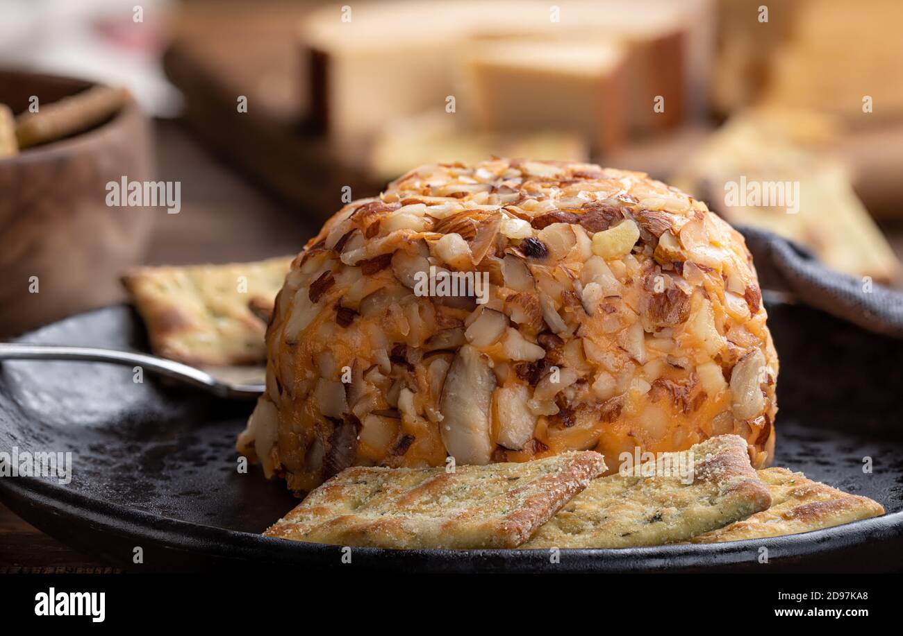 Closeup of a cheddar cheese ball and crackers on a plate Stock Photo