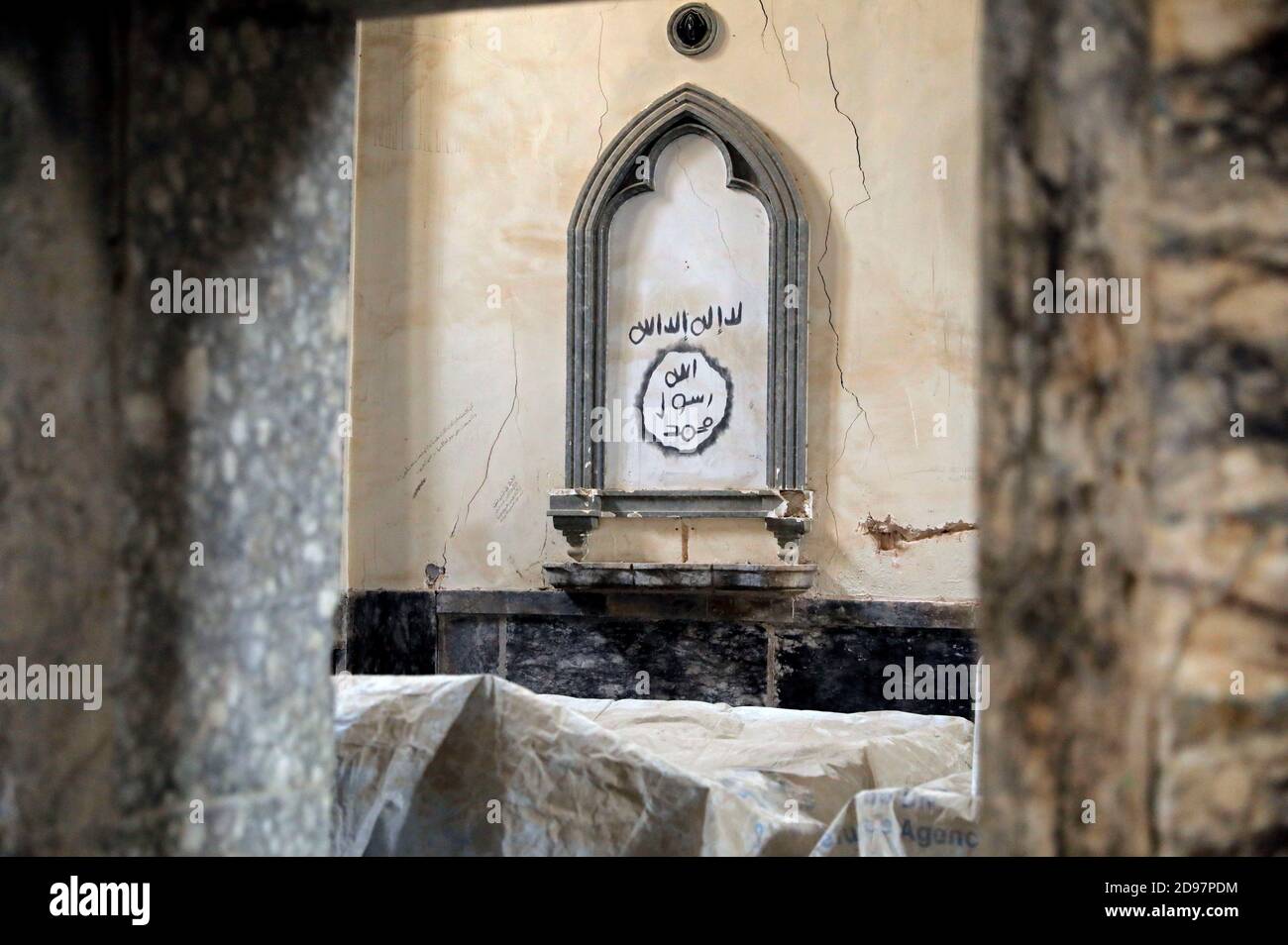 Arabic Graffiti Believed To Be Sprayed By Islamic State Militants Reading There Is No God But Allah Mohammad Is The Messenger Of Allah Is Seen On A Wall At The Church Of