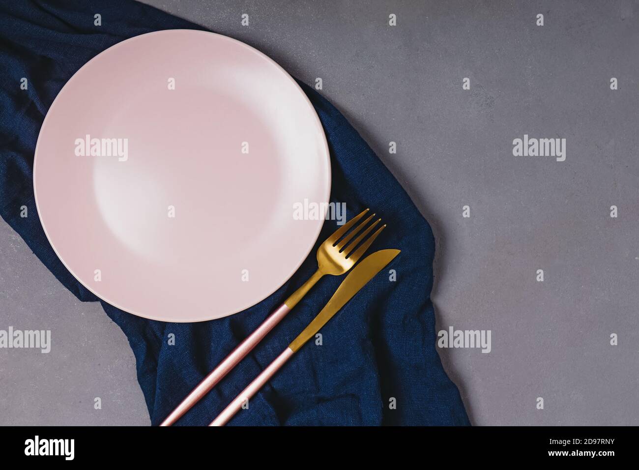 Empty pink plate on dark grey table Stock Photo