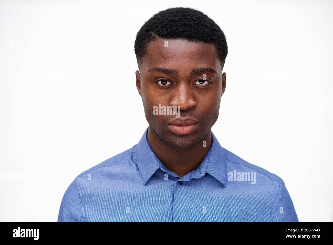 Close up portrait of handsome young black man against isolated white ...
