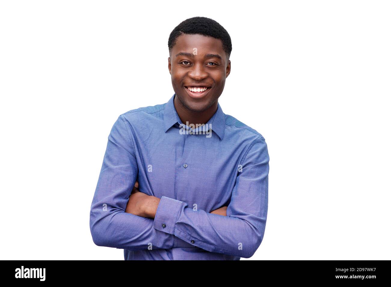 Portrait of smiling young black man in blue shirt posing with arms ...
