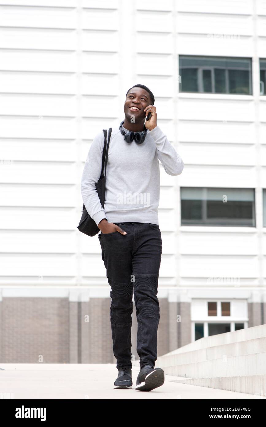 Happy young black man walking hi-res stock photography and images - Alamy