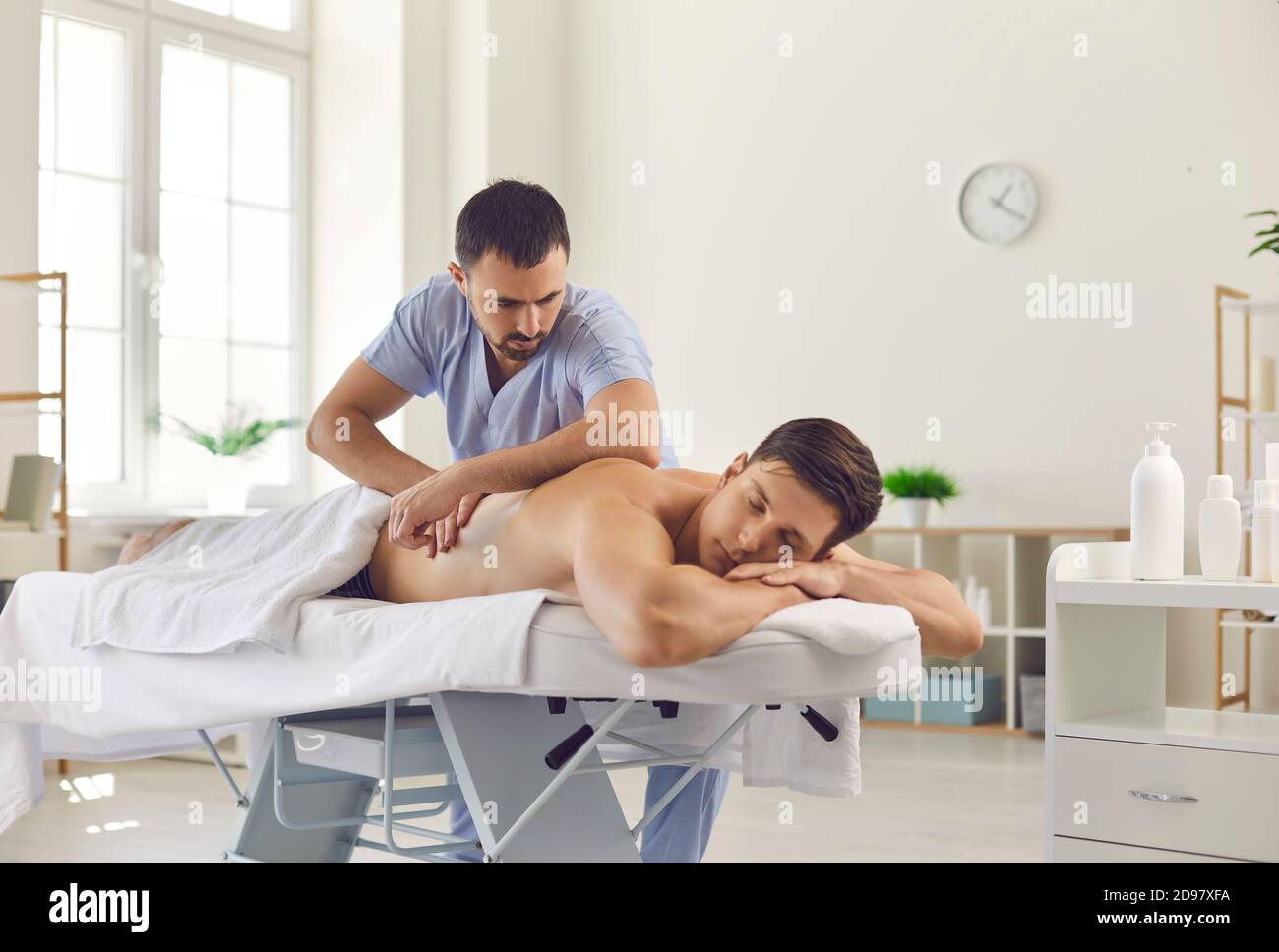 Man chiropractor making acupressure, manual therapy or rehabilitation massage Stock Photo