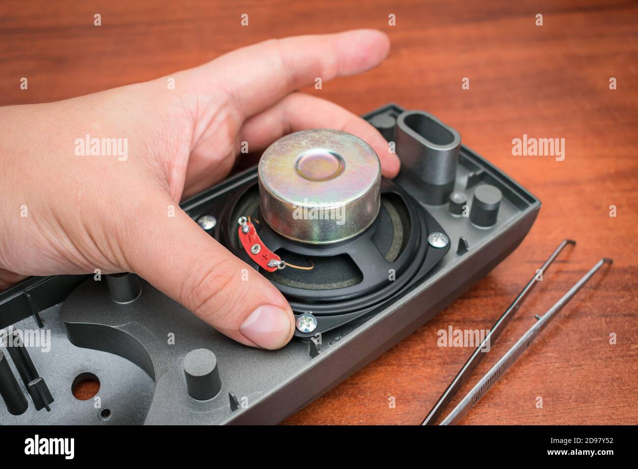 Loudspeaker repair process. The master changes the speaker by hand