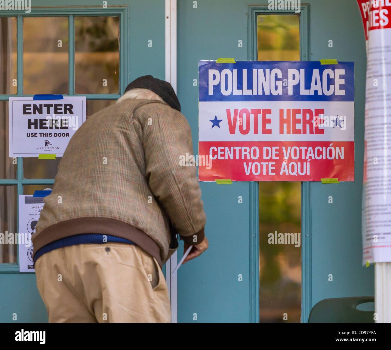 ARLINGTON, VIRGINIA, USA, NOVEMBER 3, 2020 - Man enters polling place during voting on presidential election day in northern Virginia. Credit: ©Rob Crandall/Alamy Live News Stock Photo