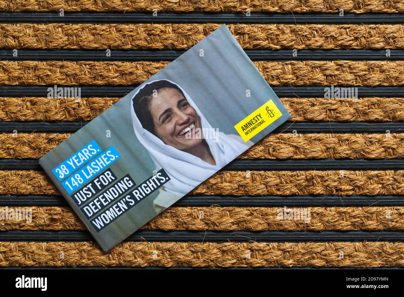 Post mail on doormat - charity appeal, Amnesty International 38 years 148 lashes just for defending women's rights Stock Photo