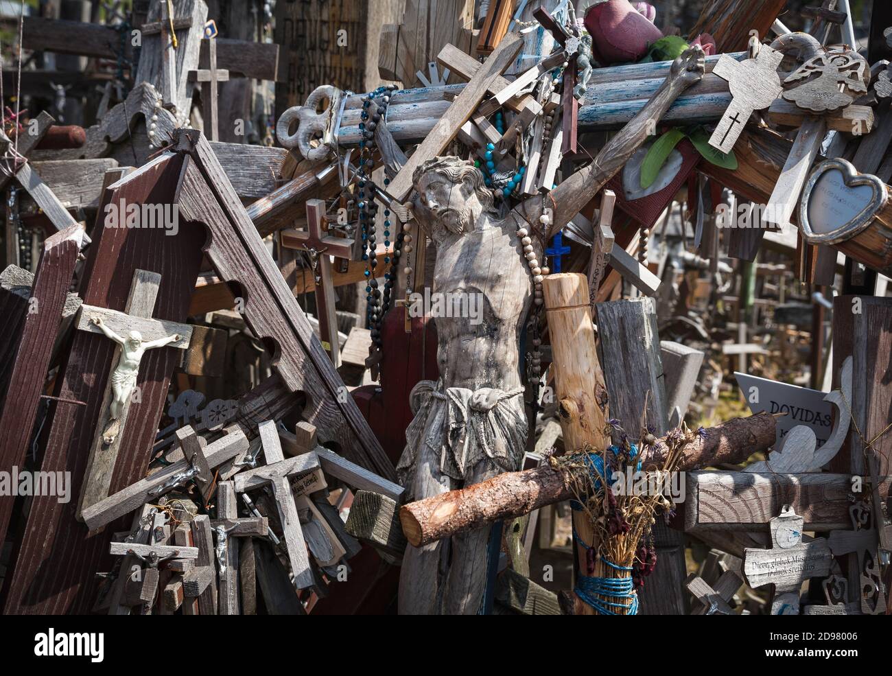 Hill of Crosses is a unique monument of history and religious folk art in Siauliai, Lithuania. Text on the crosses in different languages - O God, pro Stock Photo