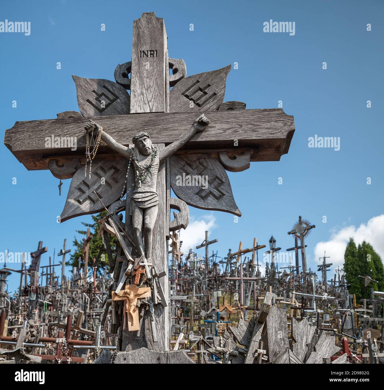Hill of Crosses is a unique monument of history and religious folk art in Siauliai, Lithuania. Text on the crosses in different languages - O God, pro Stock Photo