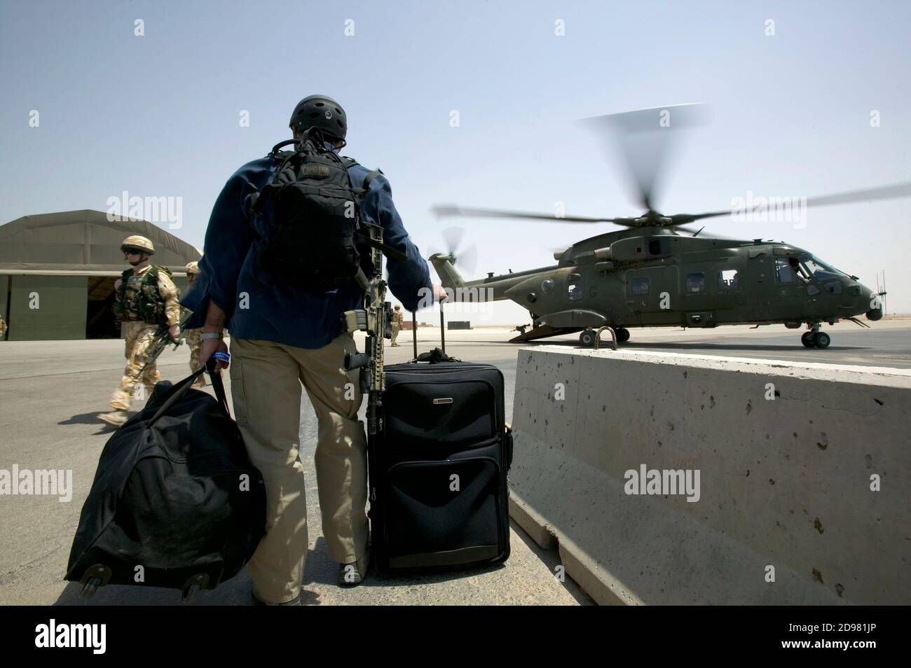A private security guard prepares to board a British helicopter. For security reason most personal  move around by air rather than by road. Stock Photo