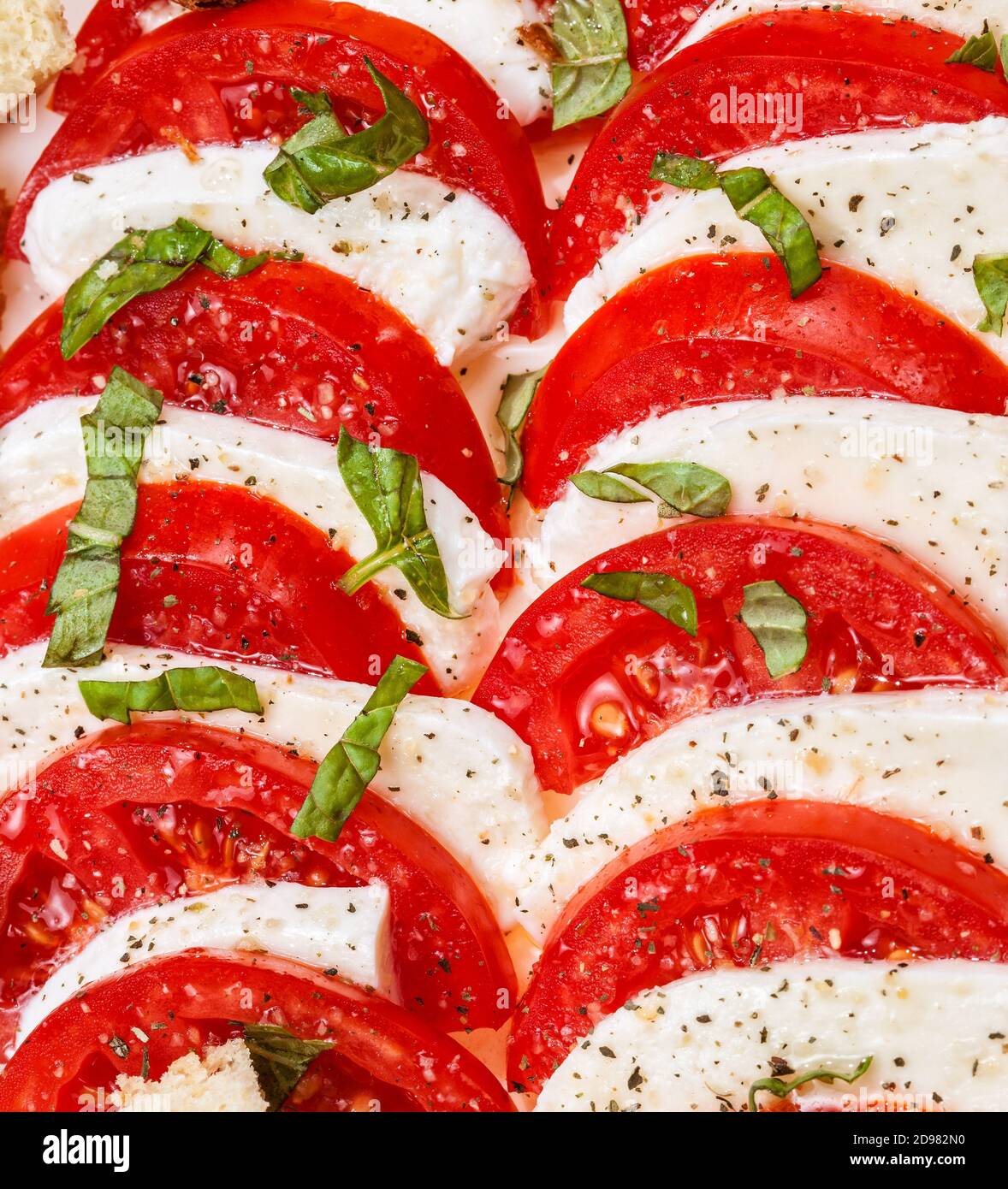 Tomato and mozzarella slices with basil leaves Stock Photo - Alamy