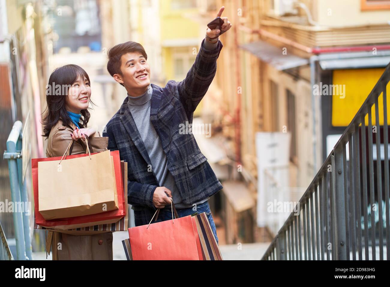 happy young asian couple going on a shopping spree Stock Photo