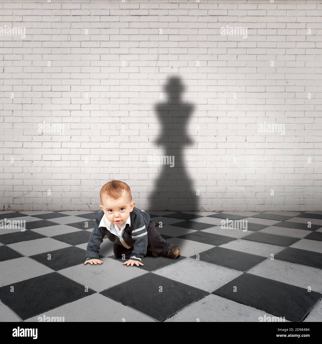 little boy with king shadow on a checkered floor Stock Photo