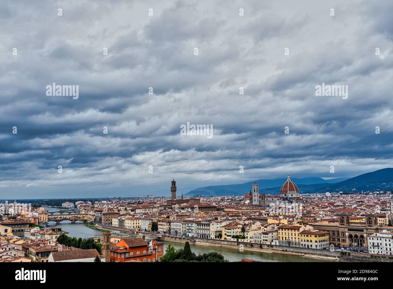 Florence Italy cityscape panorama with clouds looming above. Bird’s eye