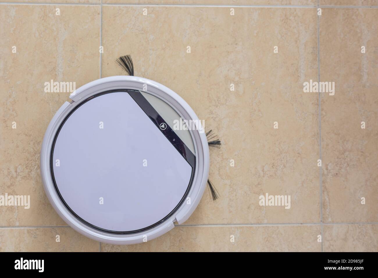 Robot vacuum cleaner cleaning the floor of the dining room of a house