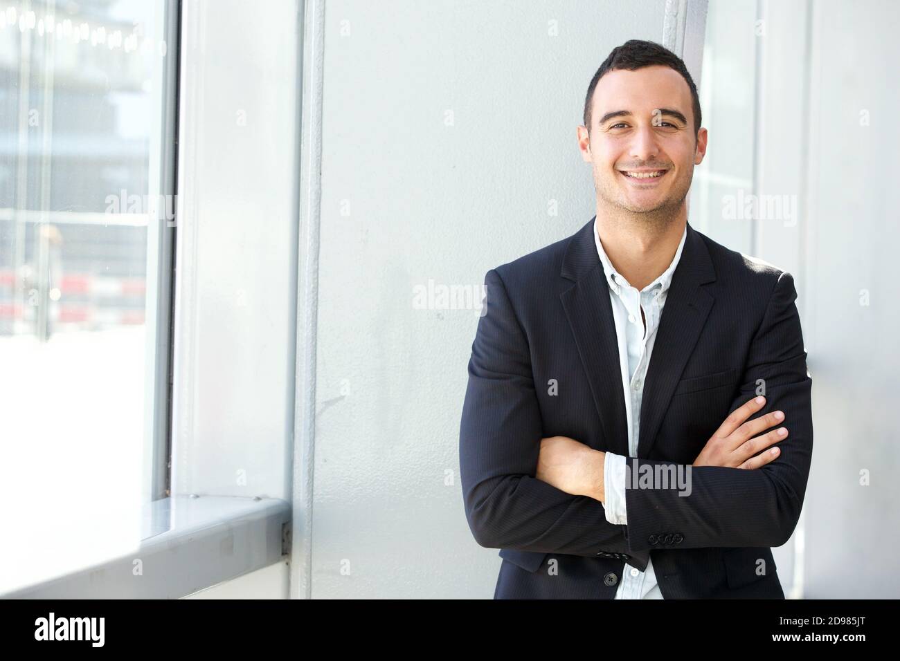 Portrait of happy businessman posing with arms crossed Stock Photo - Alamy