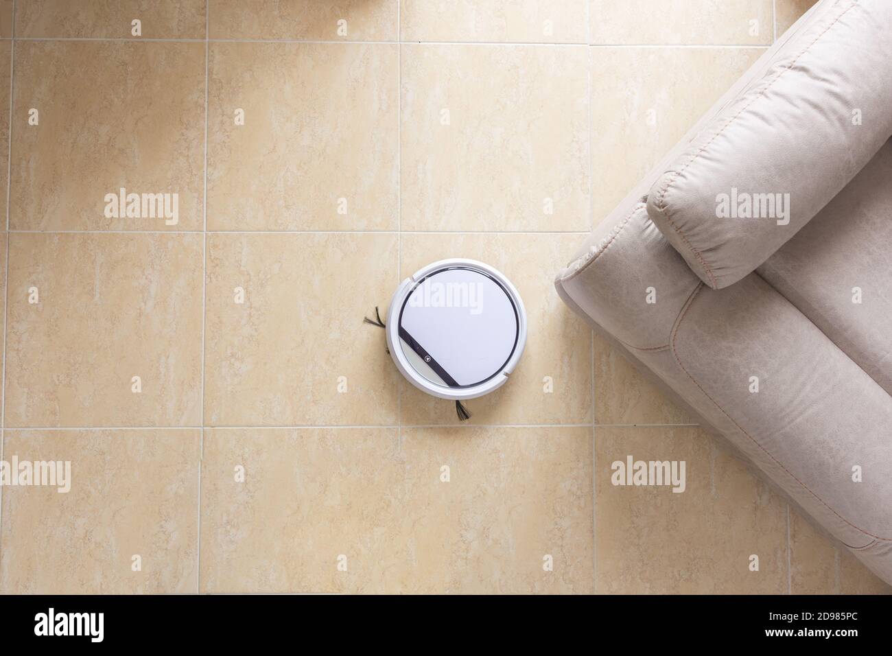 Robot vacuum cleaner cleaning the floor of the dining room of a house