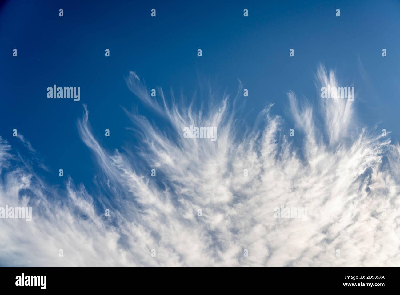 frayed cirrus clouds on deep blue sky Stock Photo