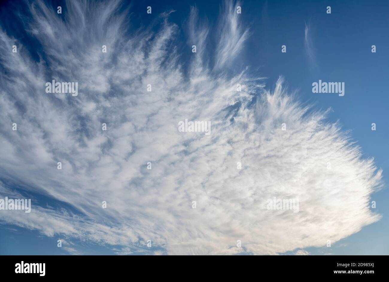 frayed cirrus clouds on deep blue sky Stock Photo