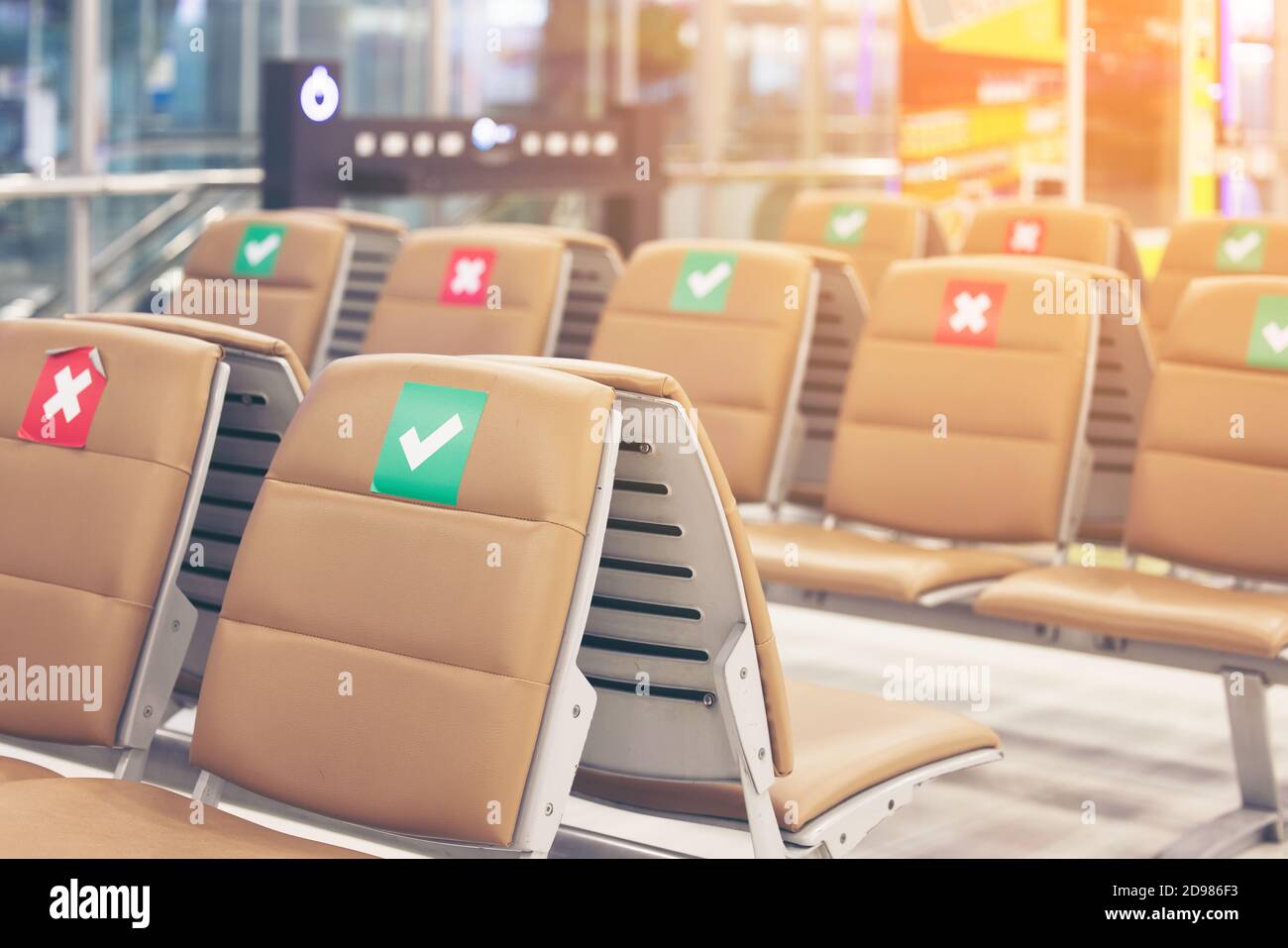 Symbol sticker on chair in international airport. New Normal and social distancing concepts, protection Coronavirus disease (Covid-19) infection Stock Photo