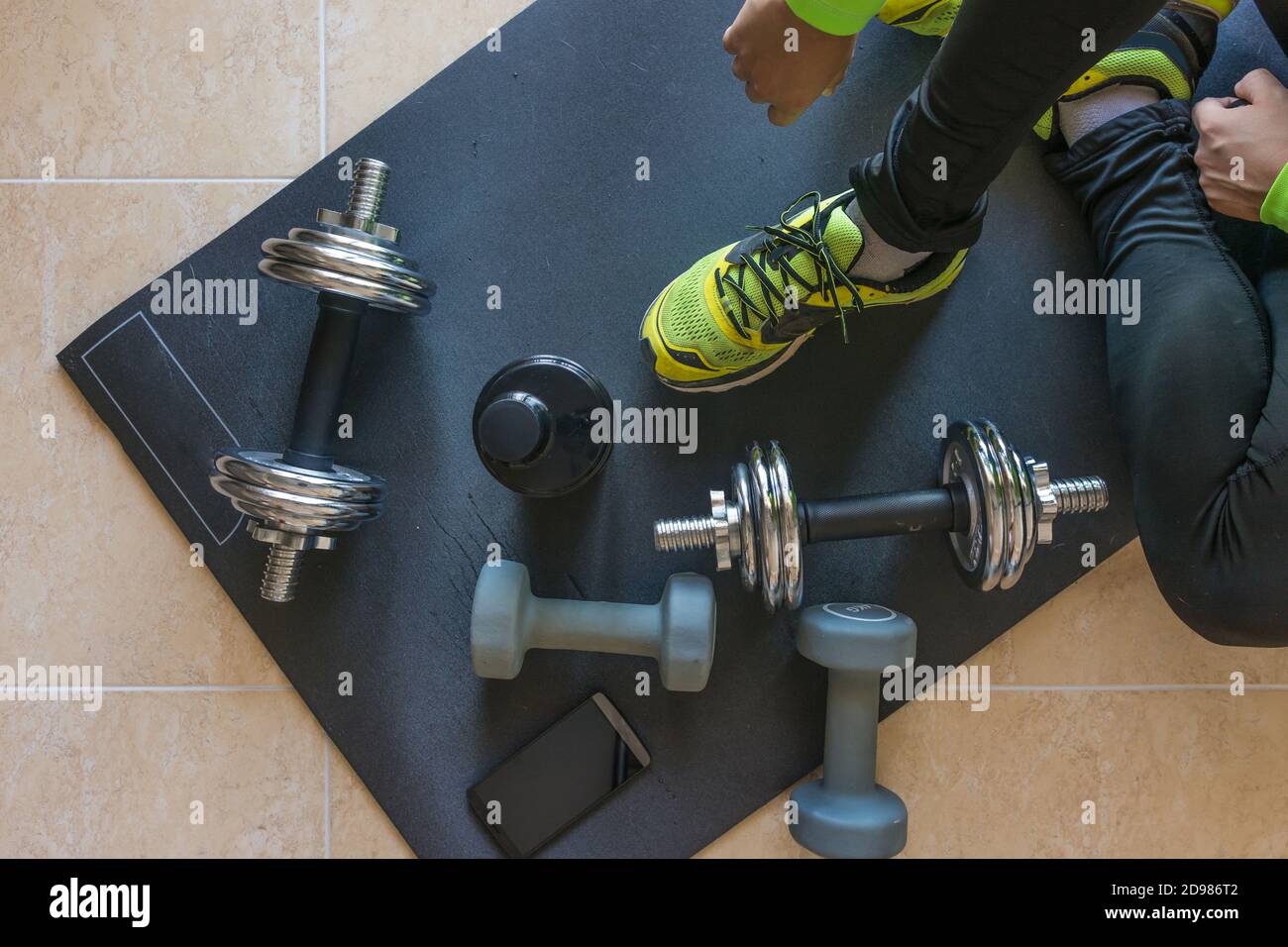 Dumbbell and mat training at home, and to drink a protein shake Stock ...