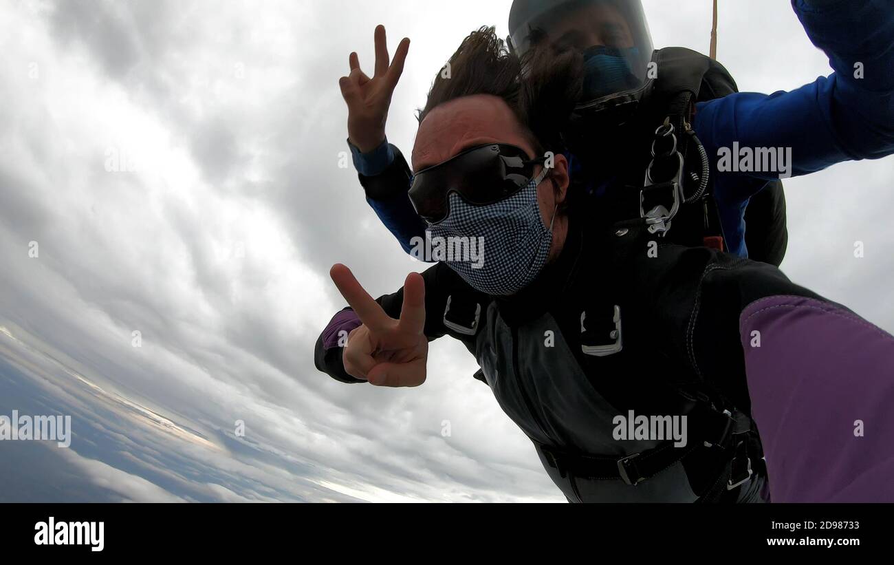 Skydiving tandem with protective mask after the lockdown Stock Photo