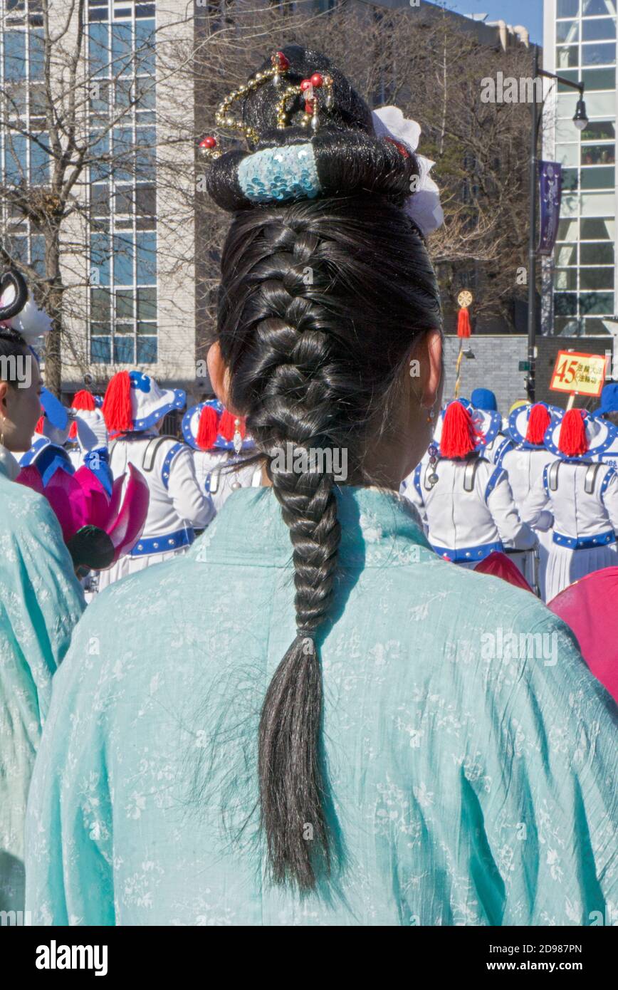 The braided ponytail of a Chinese American teenager. At the Chinese New Year's Parade in Flushing, Queens, New York City. Stock Photo