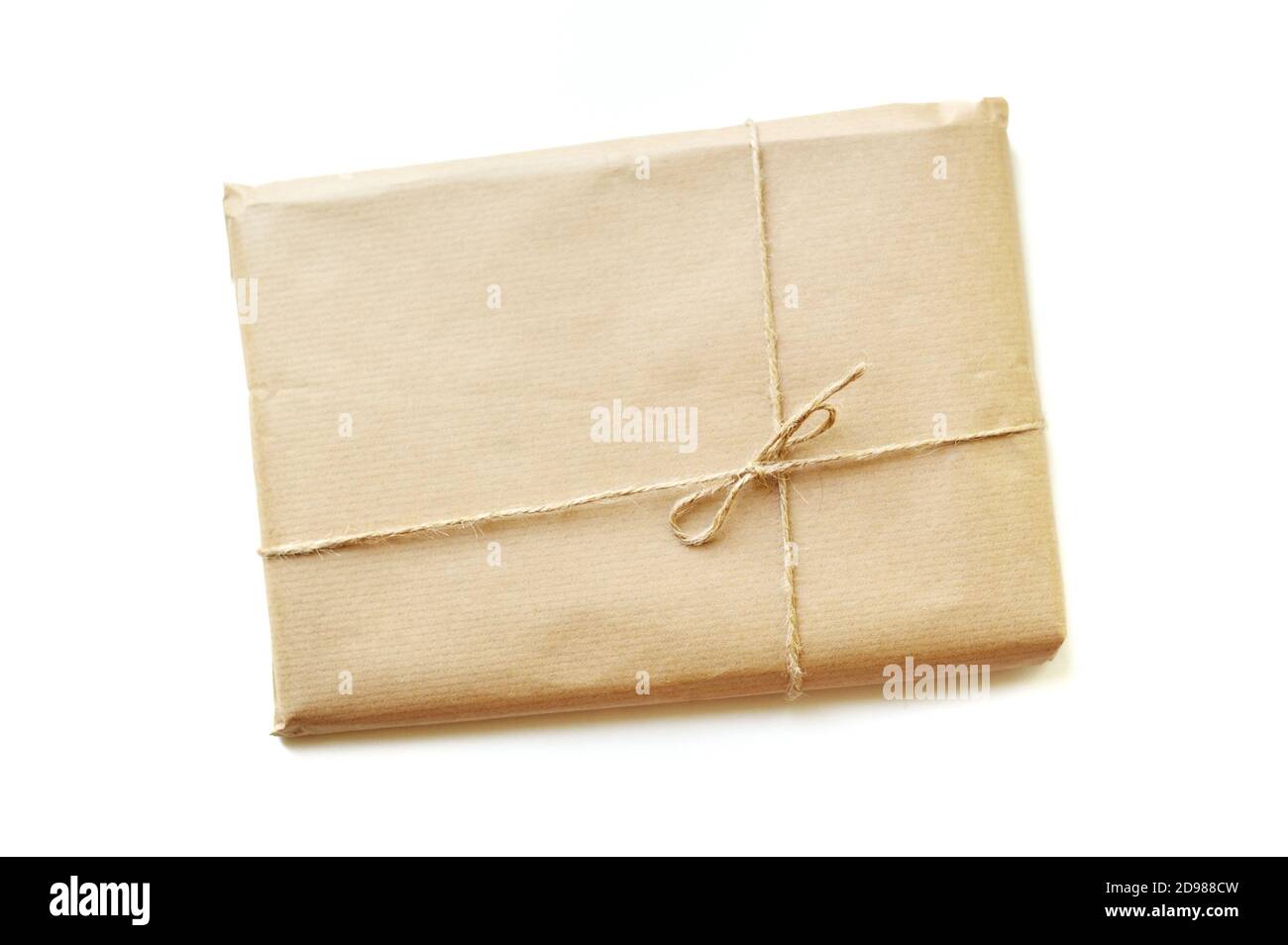 Rustic gift box packed into brown paper tied by twine with blank on