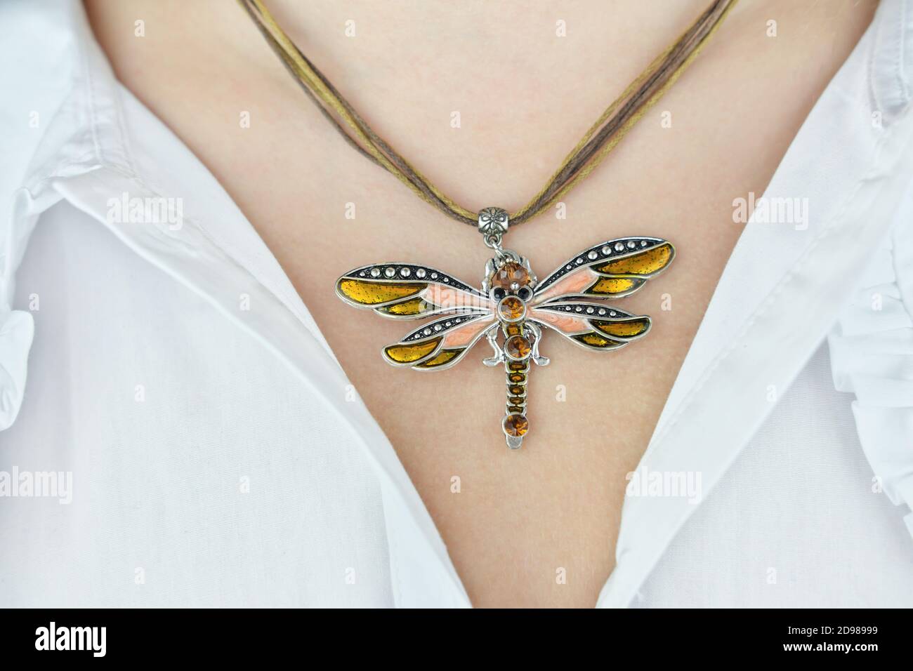 young woman neck with butterfly pendant made of enamel and metal with decorative stones.. trendy acsessories for holidays. present or gift for young girl or woman. beautiful necklace.  Stock Photo