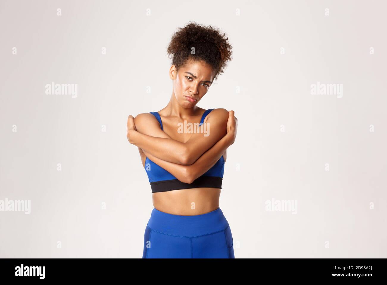 Concept of sport and workout. Sad and gloomy african-american female  athlete in sportswear, hugging herself and sulking upset, feeling  disappointed Stock Photo - Alamy