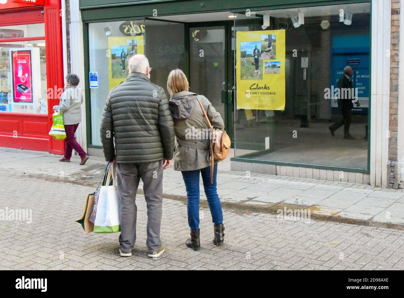 Dorchester, Dorset, UK.  3rd November 2020.   Shoppers stop to look at the sign in the window of an empty shop which was a Clarks shoe shop in South Street at Dorchester in Dorset which shut during the Covid-19 pandemic.  Picture Credit: Graham Hunt/Alamy Live News Stock Photo