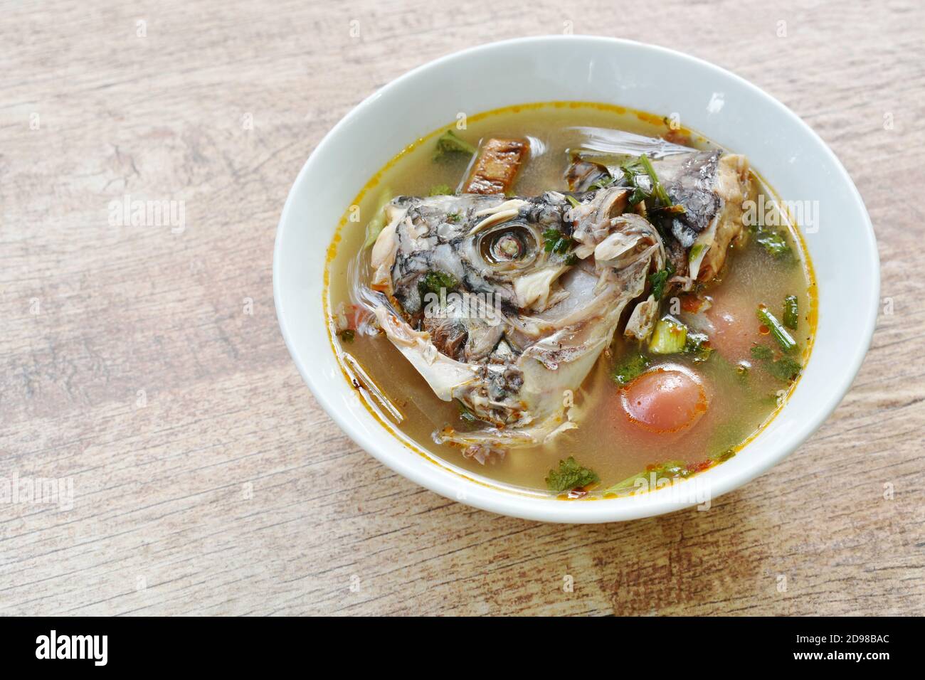 spicy boiled Tilapia head fish in tom yum soup on bowl Stock Photo Alamy