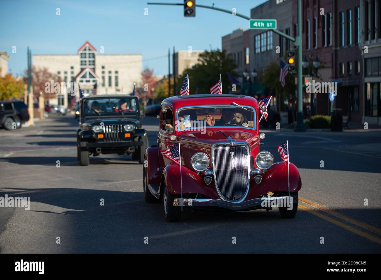 Manhattan, Kansas, USA. 1st Nov, 2020. Trump supporters drive an antique car down Poyntz Avenue on Sunday during a Turmp parade. Heartland Trump Parades hosted a Trump Parade in Manhattan, Kansas on Sunday where around 165 cars and trucks showed up to show their support for President Donald Trump. The parade started in CiCo Park and drove through Historic downtown on Poyntz Avenue. Credit: Luke Townsend/ZUMA Wire/Alamy Live News Stock Photo