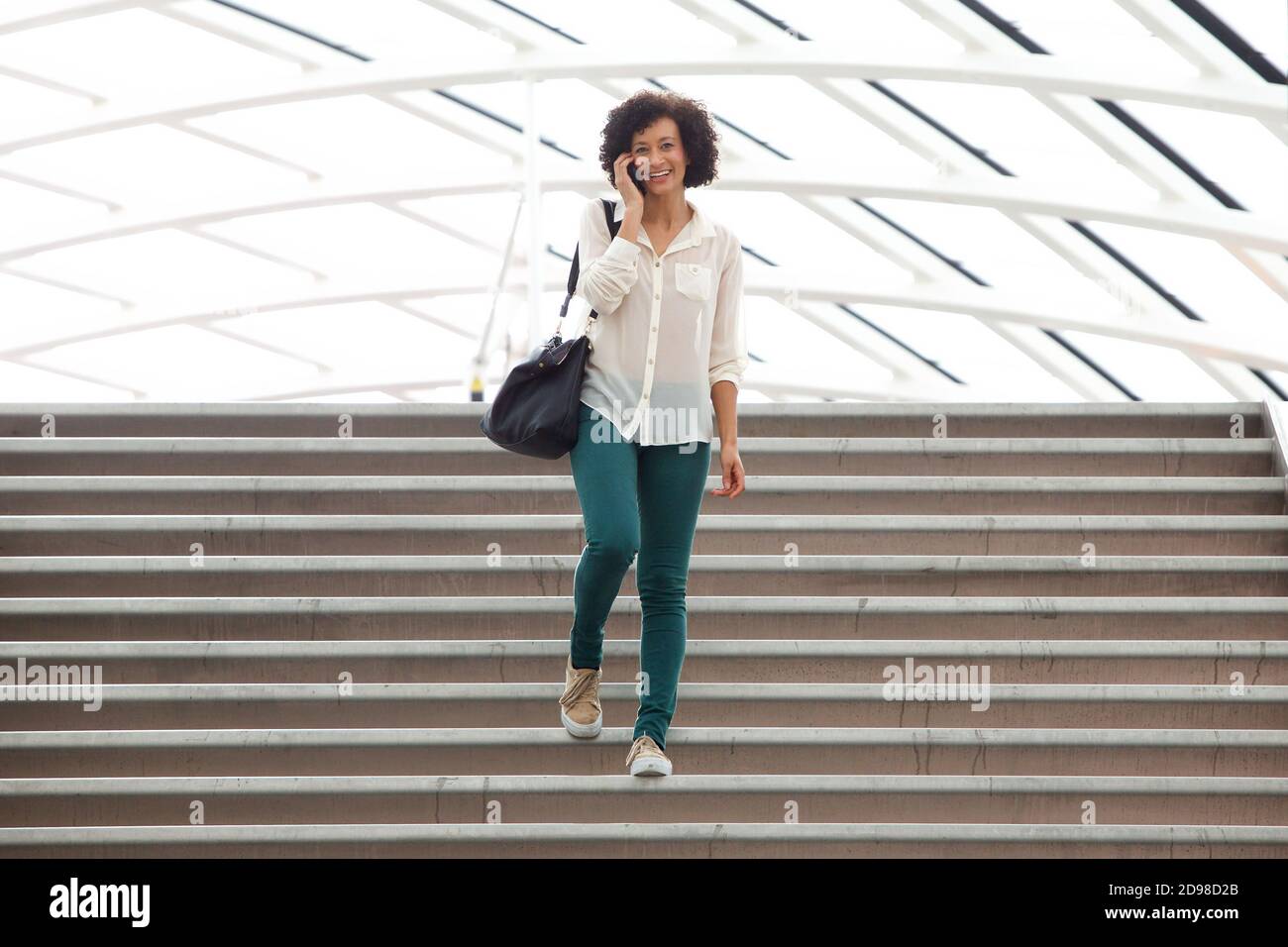 Woman walking down stairs hi-res stock photography and images - Alamy