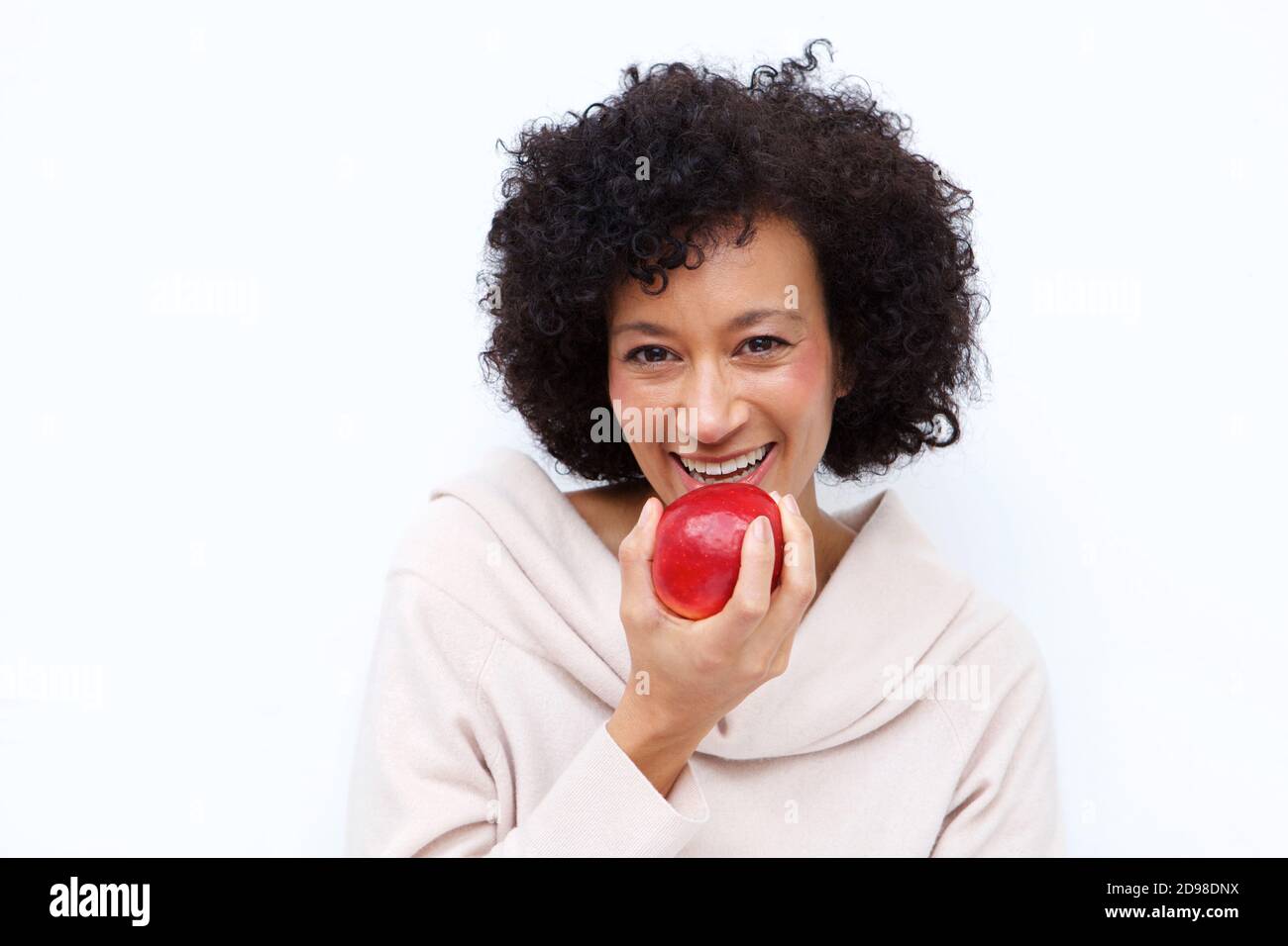 Close up portrait of healthy african american woman eating apple Stock Photo