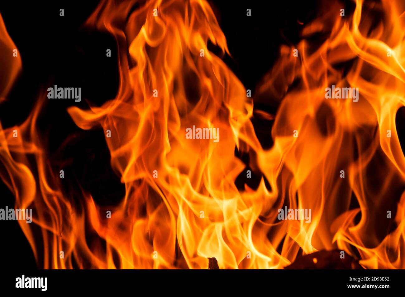 Orange fire flames on a black background Stock Photo - Alamy