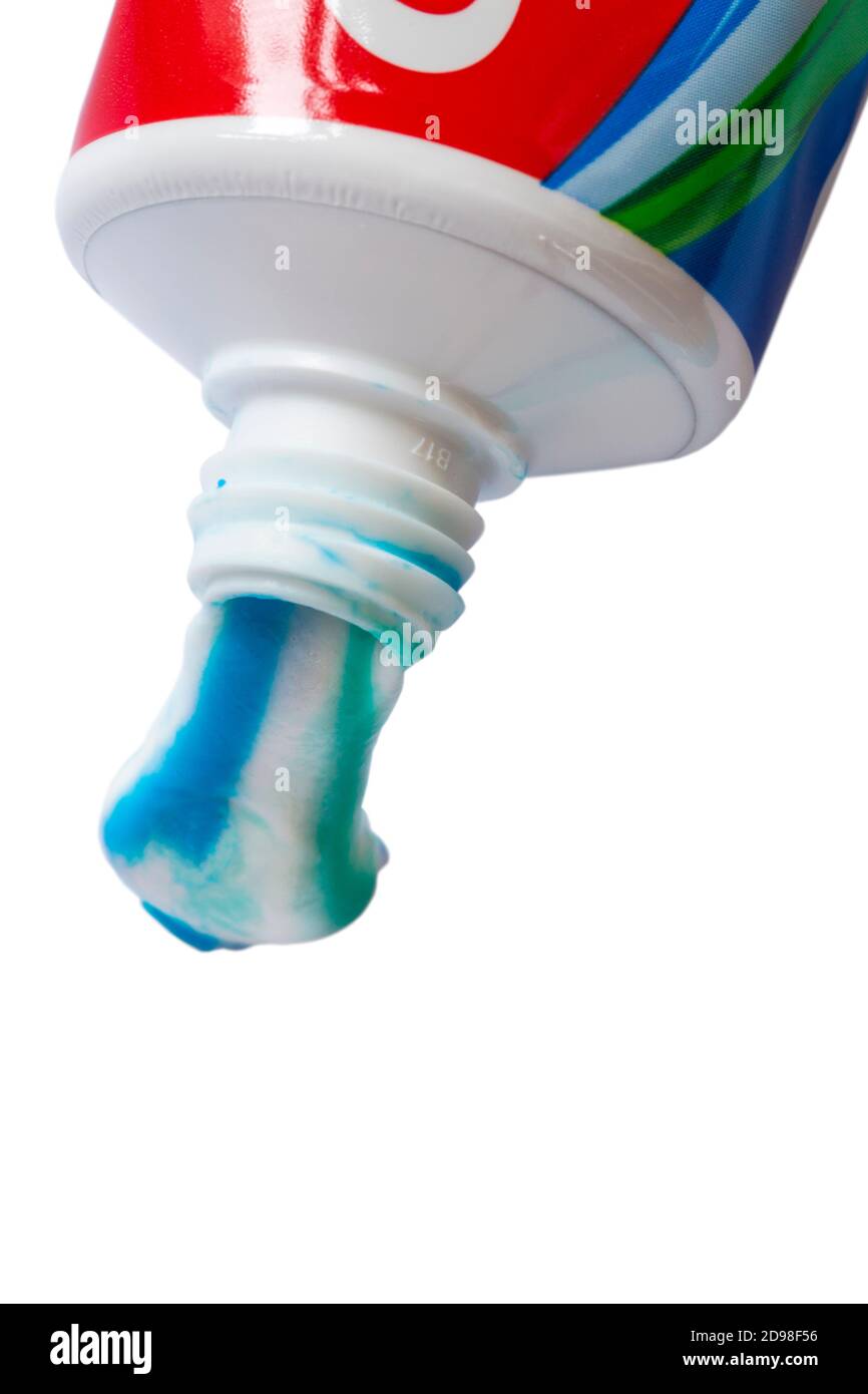 blob of toothpaste from tube of Colgate Triple Action original mint toothpaste set on white