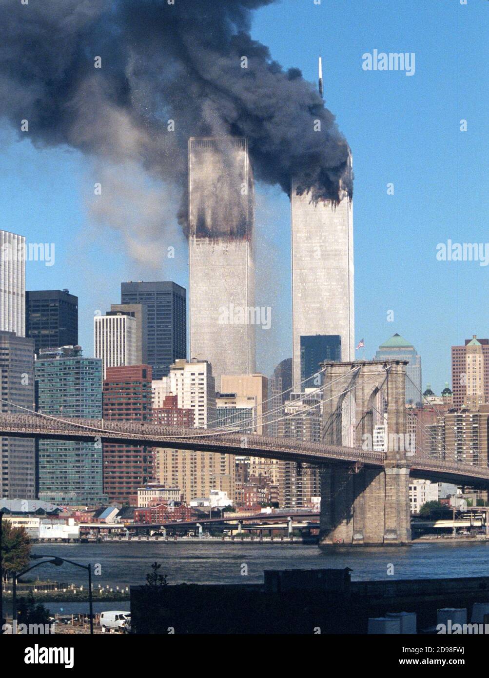 The World Trade Center moments after the South Tower was struck by United flight 175. Fire had not yet spread throughout the floors and debris can be Stock Photo